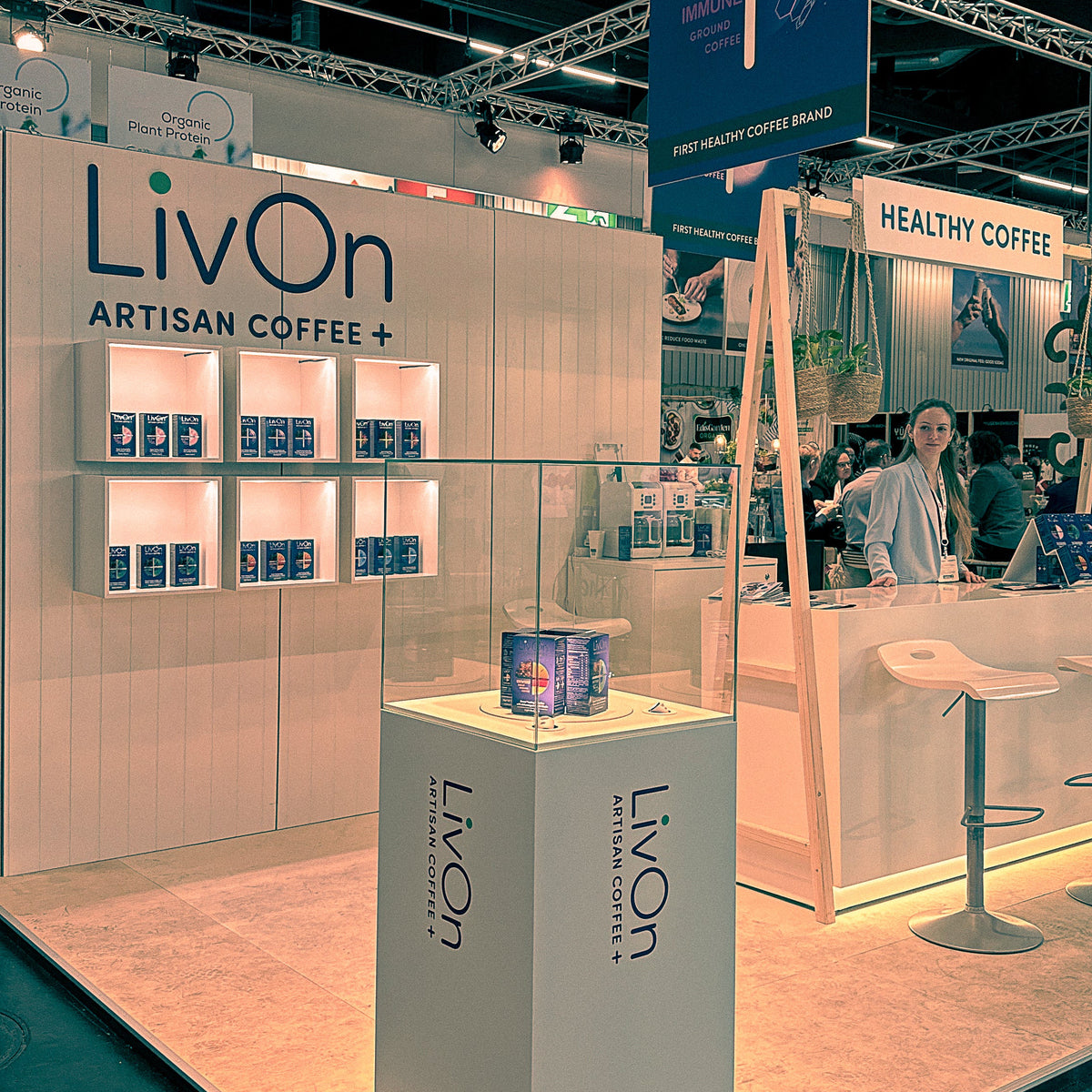 LivOn coffee booth at a trade show with branding and product display.